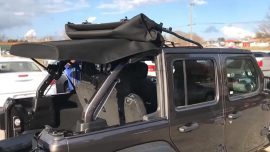 Jeep Wrangler with half of the soft top removed