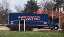 A truck with Hovis Auto & Truck Supply on the trailer is parked outside a Sheetz store